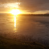 Golden sunrise reflecting across the ocean symbolizing the light of God's prophetic Word from 2 Peter 1:19
